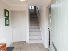 A hallway with stairs and door at 1 Coconut Cottage, Long Melford