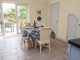 A dining room with a table set for dinner at 1 Coconut Cottage, Long Melford