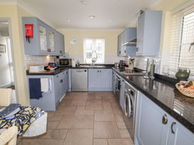 A kitchen with cabinets and appliances at 1 Coconut Cottage, Long Melford