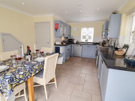 A kitchen with a dining table and chairs at 1 Coconut Cottage, Long Melford