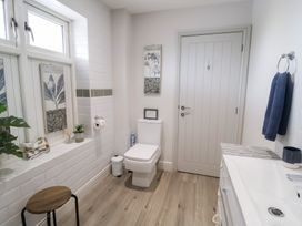 A bathroom with a toilet and sink at 1 Coconut Cottage, Long Melford