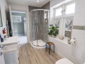 A bathroom with a shower and sink at 1 Coconut Cottage, Long Melford