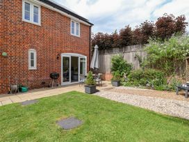 A garden with a patio and seating area at 1 Coconut Cottage, Long Melford