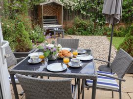 A garden dining setup with table and chairs at 1 Coconut Cottage, Long Melford