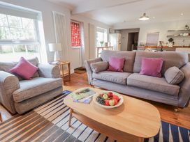 A living room with a sofa and armchair at Fig Cottage, Pettistree Near Woodbridge