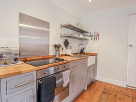 A kitchen with appliances and utensils at Fig Cottage, Pettistree Near Woodbridge