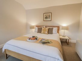 A bedroom with a bed and side tables at Fig Cottage, Pettistree Near Woodbridge