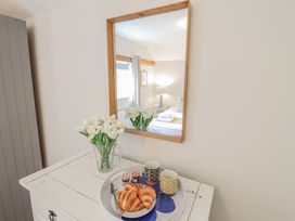 A tray with croissants and cups on a white chest at Fig Cottage, Pettistree