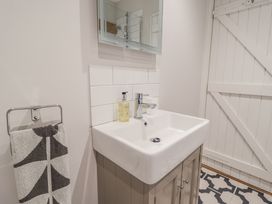 A bathroom with a sink and mirror at Fig Cottage, Pettistree Near Woodbridge