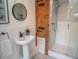 A bathroom with a shower and sink at Candle Croft Tolgus Mount near Redruth