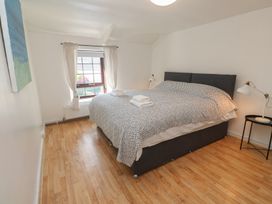 A bedroom with a bed and window at Candle Croft in Tolgus Mount near Redruth