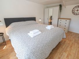 A bedroom with a large bed and wardrobe at Candle Croft in Tolgus Mount near Redruth