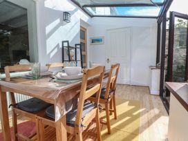 A dining room with a table and chairs at Candle Croft in Tolgus Mount near Redruth