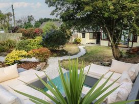 A garden with a seating area and plants at Candle Croft in Tolgus Mount near Redruth
