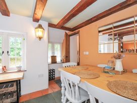 A dining room with a table and chairs at Rose Cottage Okehampton