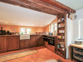 A kitchen with cabinets and appliances at Rose Cottage Okehampton