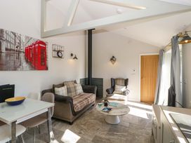 A living room with a sofa and coffee table at Bottom Lodge in Penhow