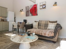 A living room with a sofa and coffee table at Bottom Lodge in Penhow