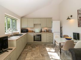 A kitchen with cabinets and appliances at Bottom Lodge in Penhow