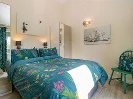 A bedroom with a bed and artwork at Bottom Lodge in Penhow