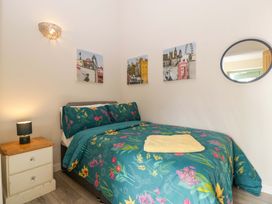A bedroom with a bed and nightstand at Bottom Lodge in Penhow