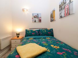 A bedroom with a bed and wall art at Bottom Lodge in Penhow