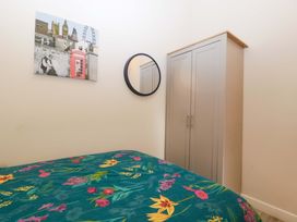 A bedroom with a bed and wardrobe at Bottom Lodge in Penhow