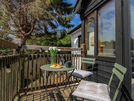 A balcony with a table and chairs at West Island in Kingsbridge