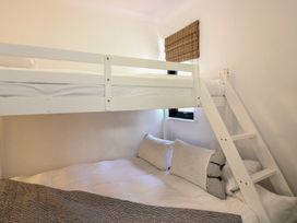 A bunk bed with pillows in a bedroom at West Island in Kingsbridge