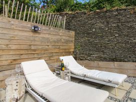 Two lounge chairs with a bottle and glasses at West Island in Kingsbridge