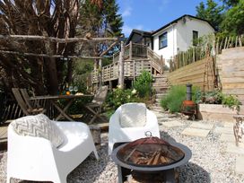 A garden with chairs and a fire pit at West Island in Kingsbridge