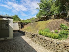 A garden with a stone wall and plants at West Island in Kingsbridge
