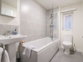 A bathroom with a bathtub shower toilet and sink at Happy Days in Bridlington