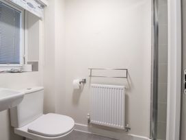 A bathroom with a toilet radiator and a shower cubicle at Happy Days in Bridlington