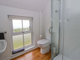A bathroom with a shower and toilet at Ceunant near Newport