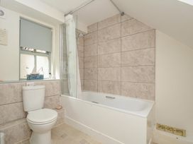 A bathroom with a bathtub and toilet at The Mews in Blisland