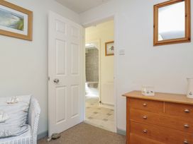 A bathroom with a door leading to another room at The Mews in Blisland