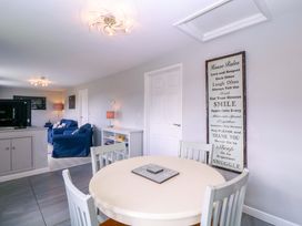 A living room with a table and chairs and a sofa at Sunny Cottage in Brecon