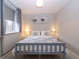 A bedroom with a double bed and nightstands at Sunny Cottage in Brecon