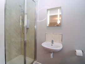 A bathroom with a shower and sink at Sunny Cottage in Brecon