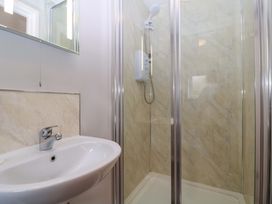 A bathroom with a sink and shower at Sunny Cottage in Brecon