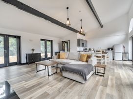 A living room with a sofa and dining area at The Annex in Wimborne Minster