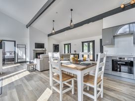 An open plan living and dining area with a dining table and kitchen at The Annex Wimborne Minster
