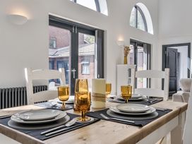 A dining room with a table set for dinner at The Annex Wimborne Minster