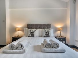 A bedroom with a bed and pillows at The Annex in Wimborne Minster