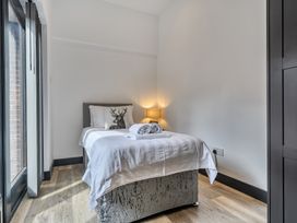 A bedroom with a bed and lamp at The Annex in Wimborne Minster