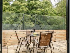 An outdoor patio with a table and chairs at The Annex in Wimborne Minster