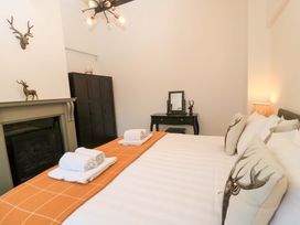 A bedroom with a bed and decorative items at The Annex in Wimborne Minster