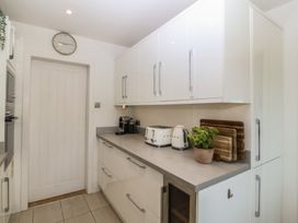 A kitchen with cabinets and appliances at Trem Ynys near Abersoch