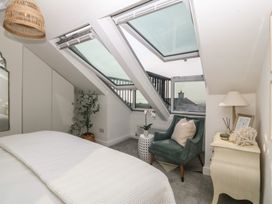 A bedroom with skylights and a plant at Trem Ynys in Mynytho near Abersoch